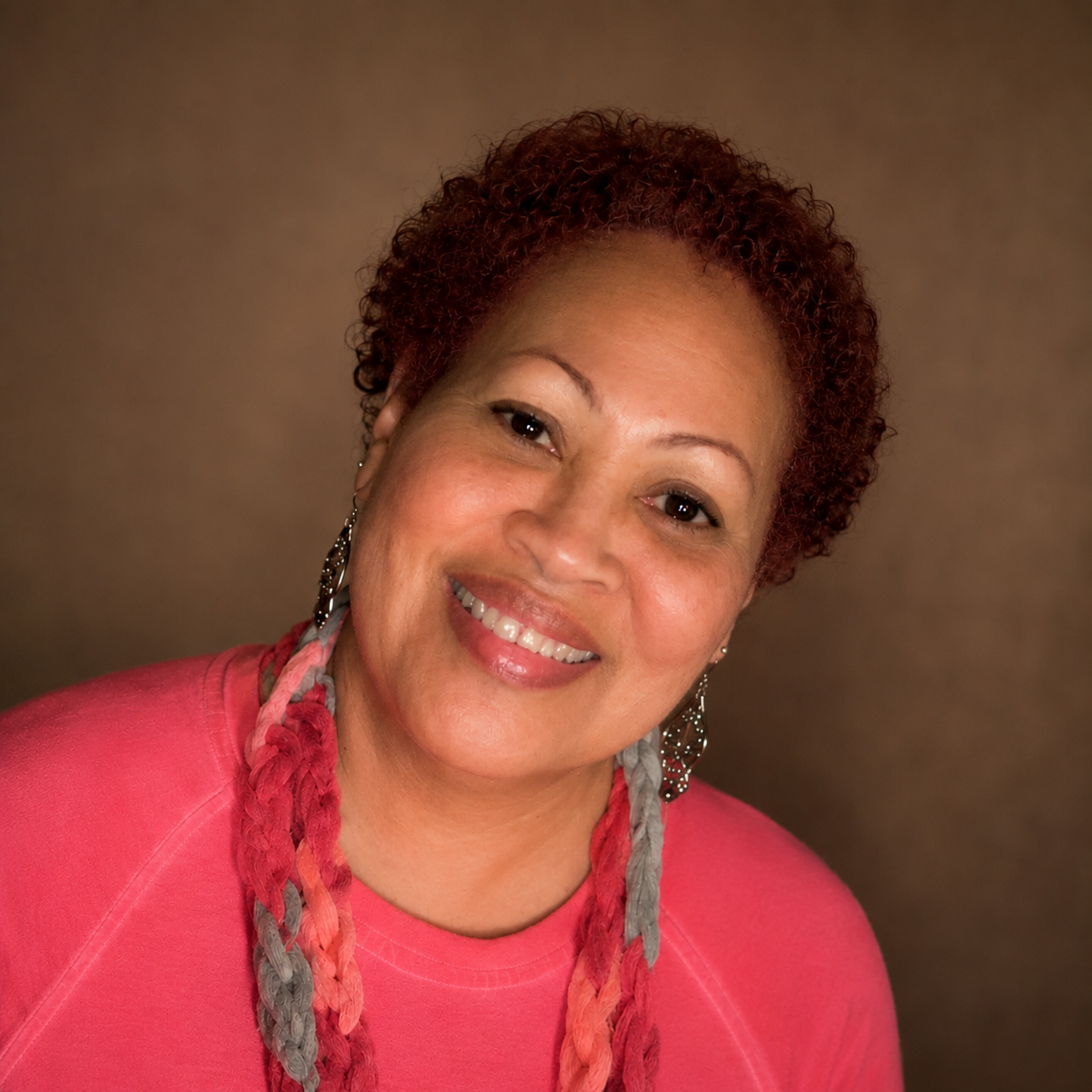 Katrina Carter, the maker behind K. Carter Jewelry and Crafts, wearing a pair of her own handmade crocheted earrings